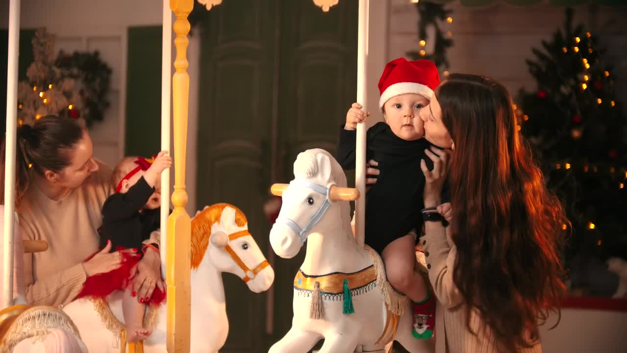 Video Stock Portrait Of Two Moms With Their Babies At A Carousel Live Wallpaper Free - Free Download