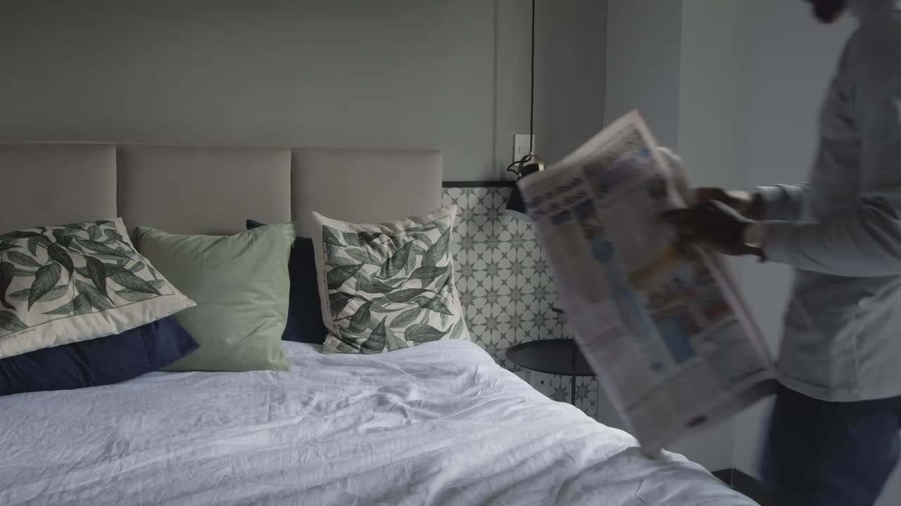 Free Stock Video Young Man Laying On A Bed Reading The Newspaper Live Wallpaper - Free Download