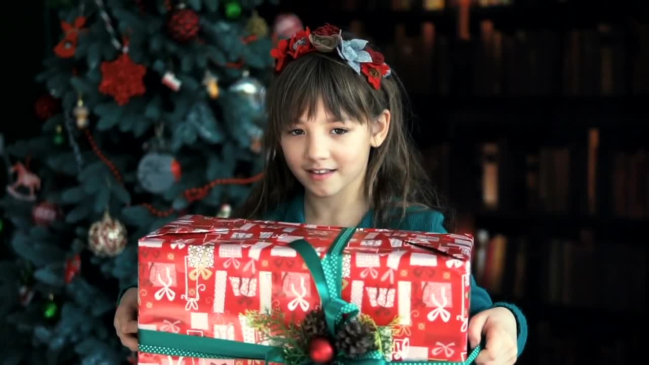 Stock Video Happy Little Girl Waving Her Christmas Gift Animated Wallpaper - Free Download