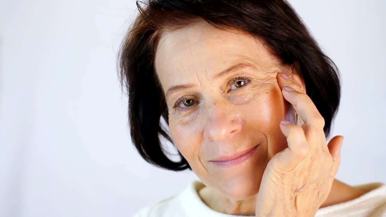 Stock Video Old Woman Massaging Skin On Her Face Live Wallpaper - Free Download
