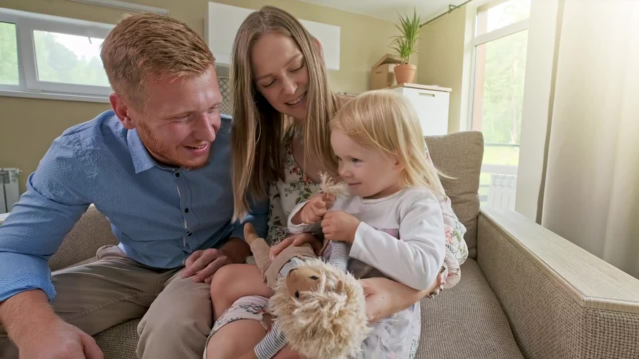 Stock Video Happy Family In An Armchair In Their New House Animated Wallpaper - Free Download