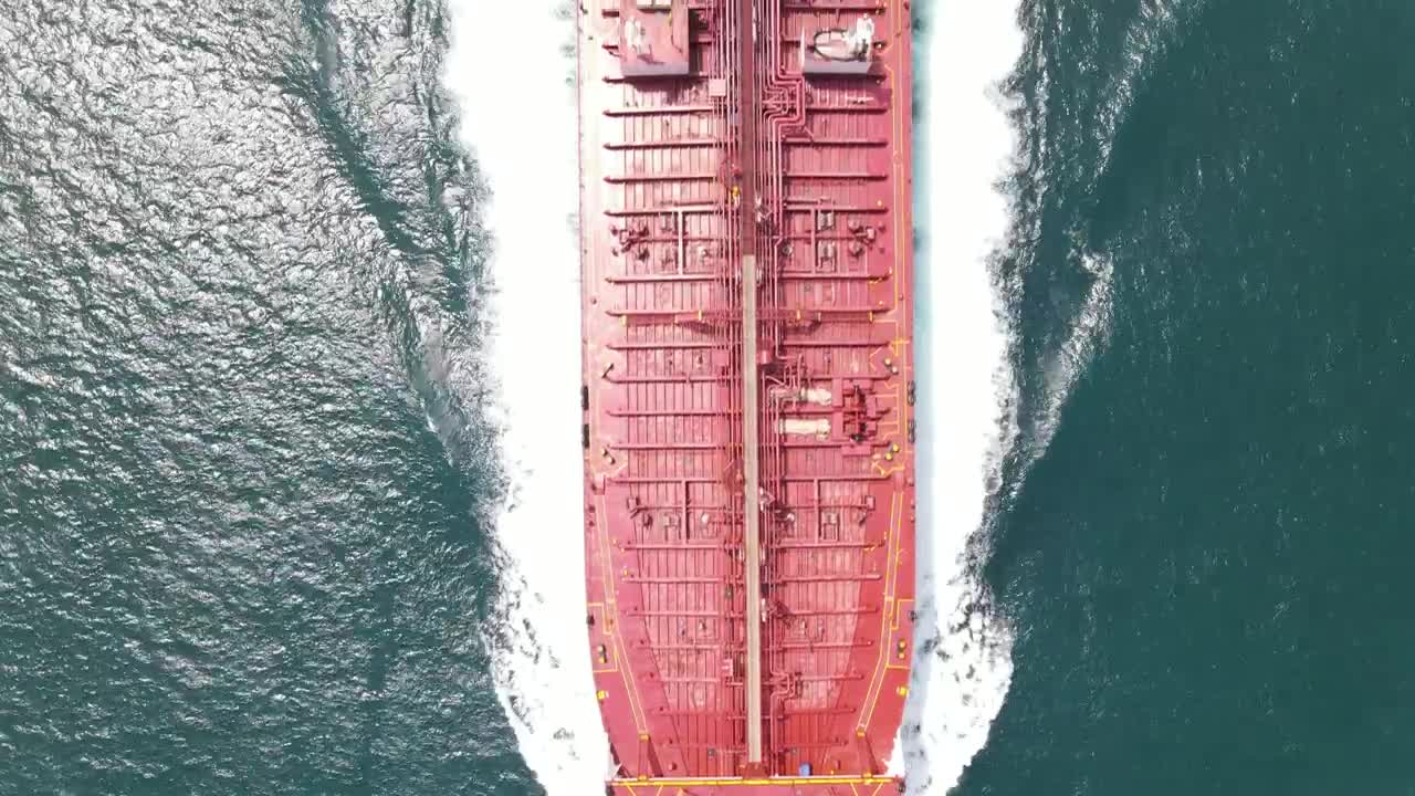 Free Video Stock top aerial shot of a cargo ship sailing in sea Live Wallpaper - Free Download