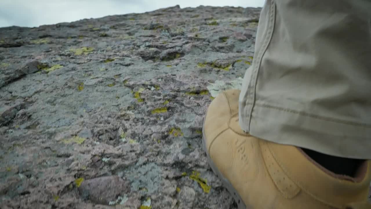 Stock Video Man With Yellow Boots Walking On A Ston Animated Wallpaper - Free Download