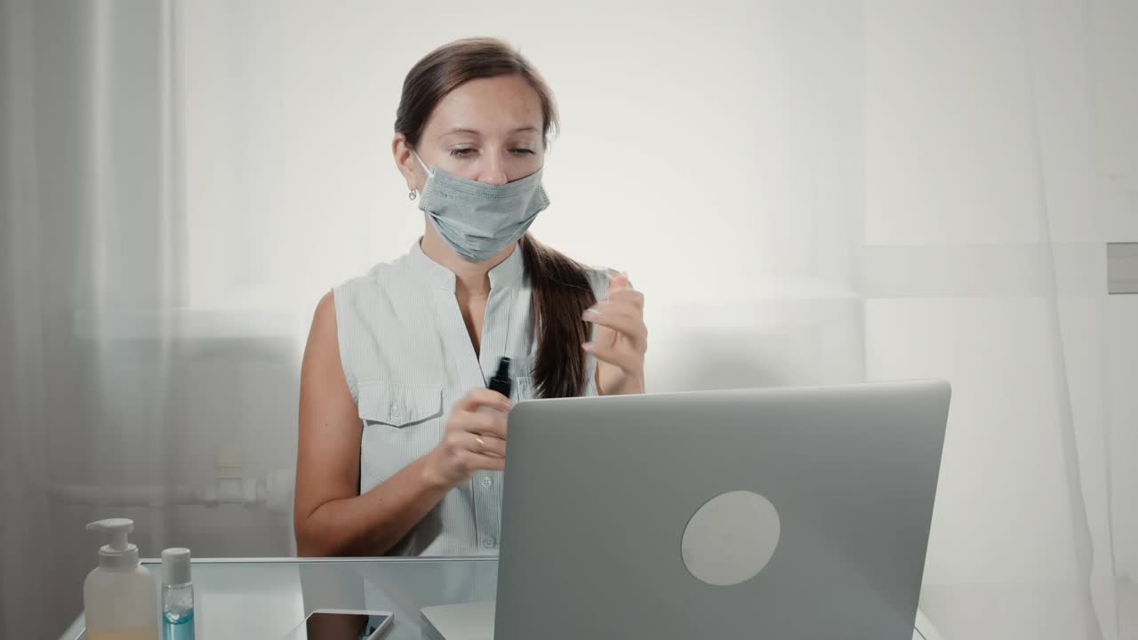 Free Stock Video Woman Using Hand Sanitizer Before Using Laptop Live Wallpaper - Free Download