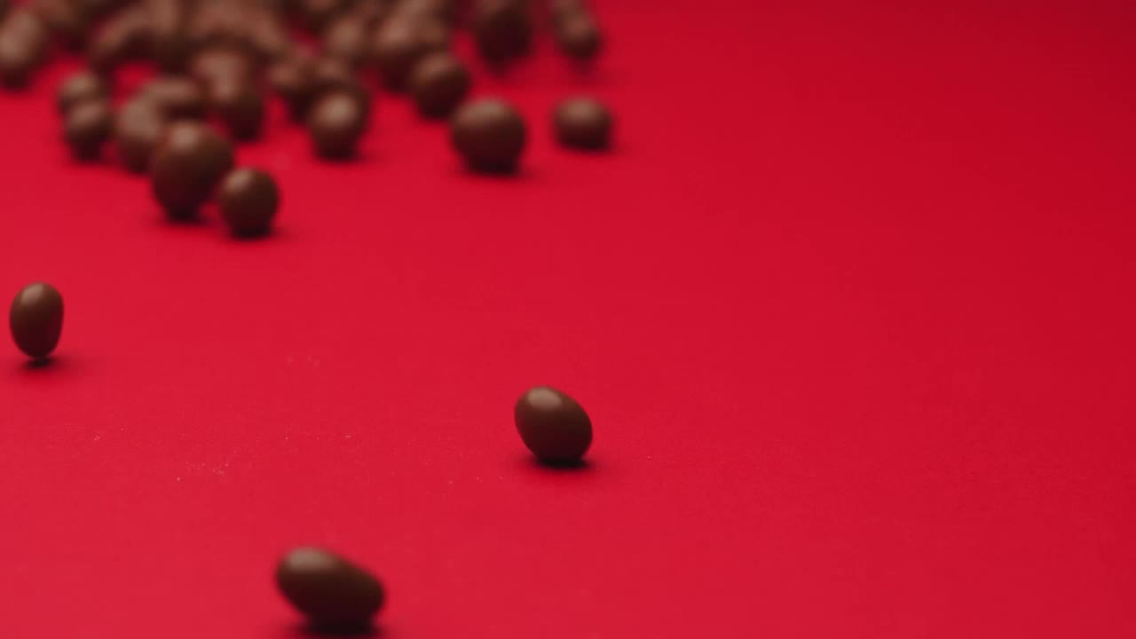 Video Stock Chocolate Beans Rolling On A Red Surface Live Wallpaper For PC - Free Download