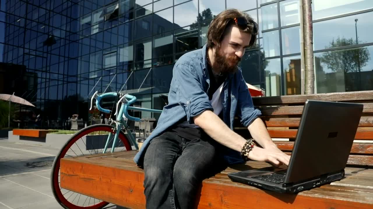 Stock Video Man Surfs Internet On Laptop From Street Benc Animated Wallpaper - Free Download