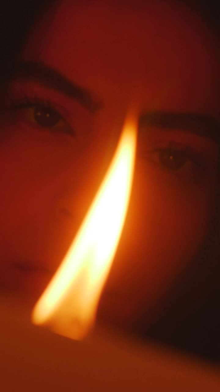 Stock Video Face Of A Young Woman Appreciating The Flame Of A Live Wallpaper For PC - Free Download