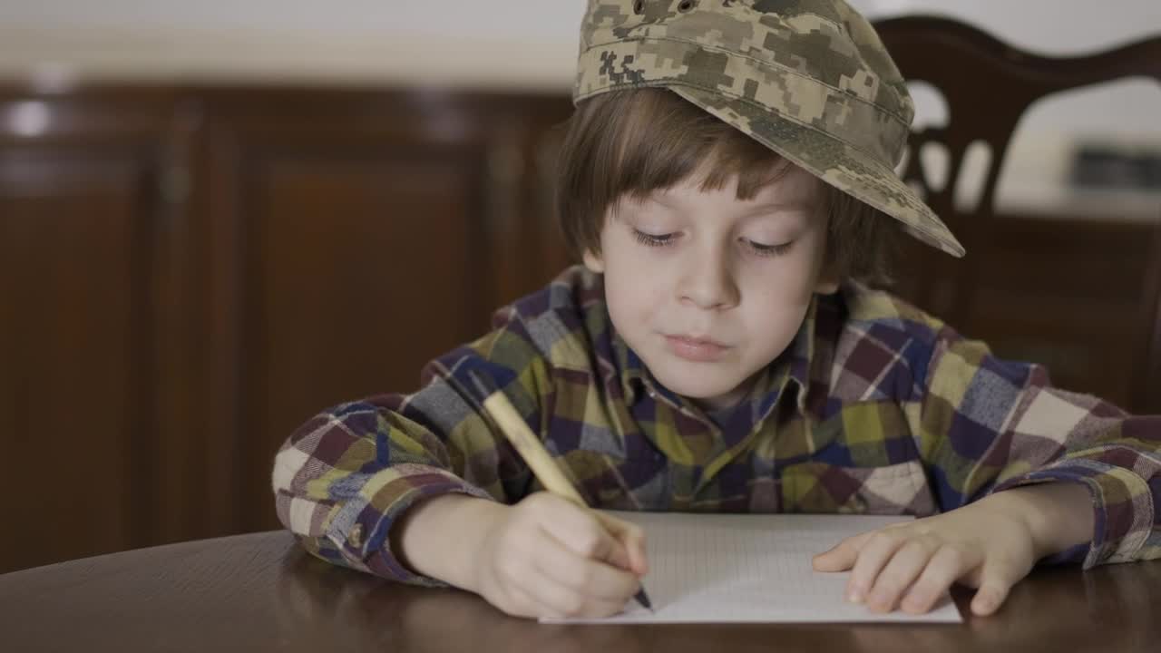 Stock Video Little Boy In Army Hat Writing Letter To Soldier Animated Wallpaper - Free Download