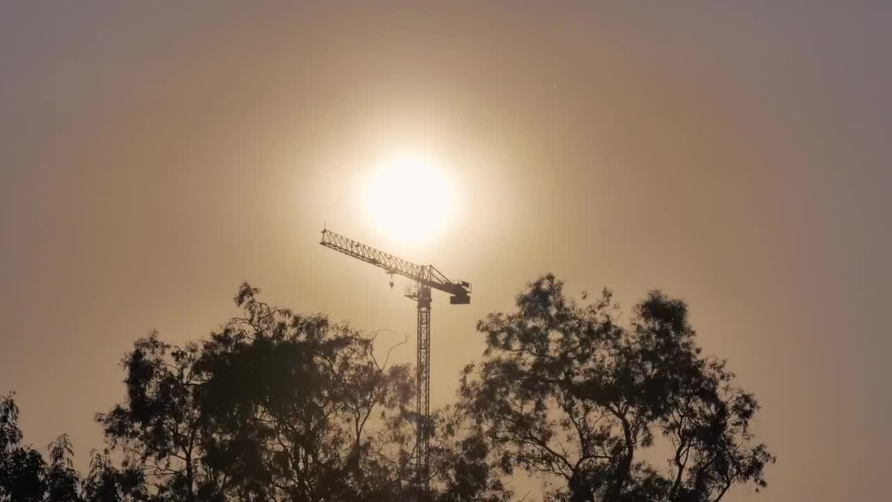 Free Video Stock tower crane during sunset seen in the distance Live Wallpaper - Free Download