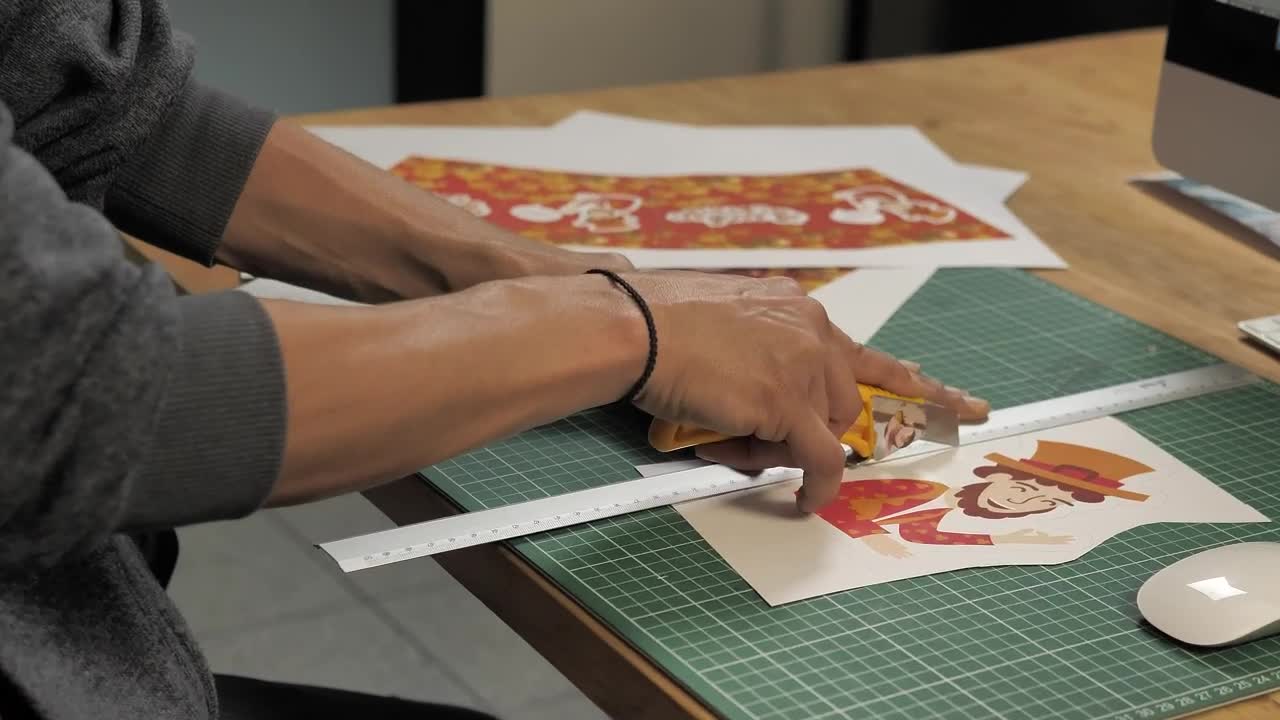 Stock Video Mans Hands Cut A Printed Illustration With A Cutte Animated Wallpaper - Free Download