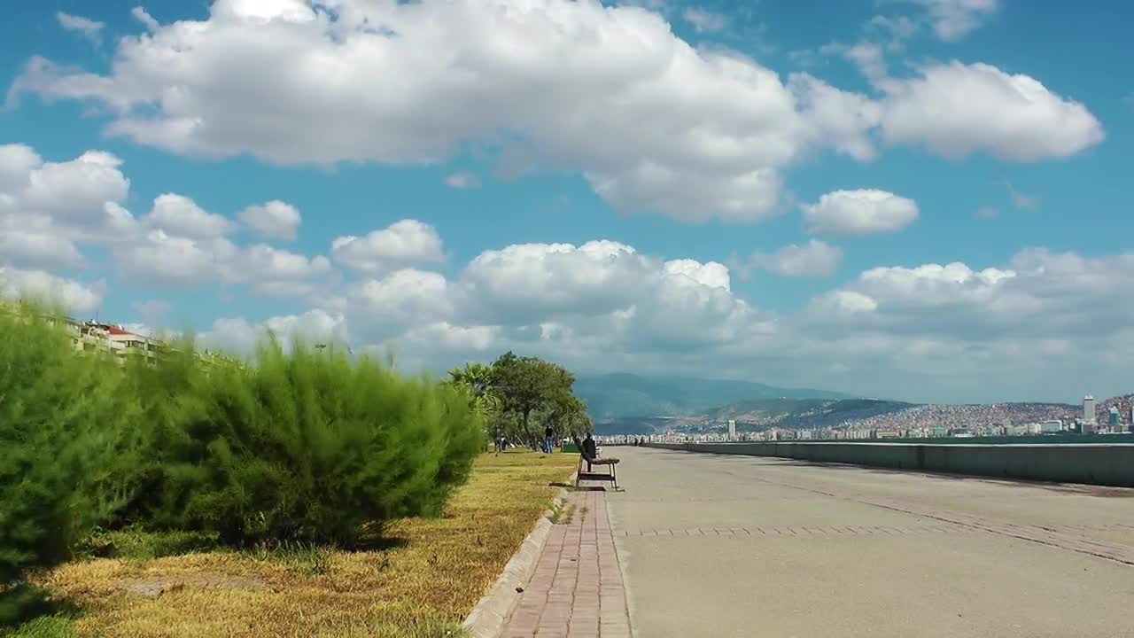 Stock Video Long Walker Beside The Sea On A Sunny Day Animated Wallpaper - Free Download