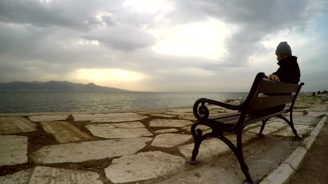 Stock Video Man Enjoying The Peace Of Seeing The Sea Animated Wallpaper - Free Download
