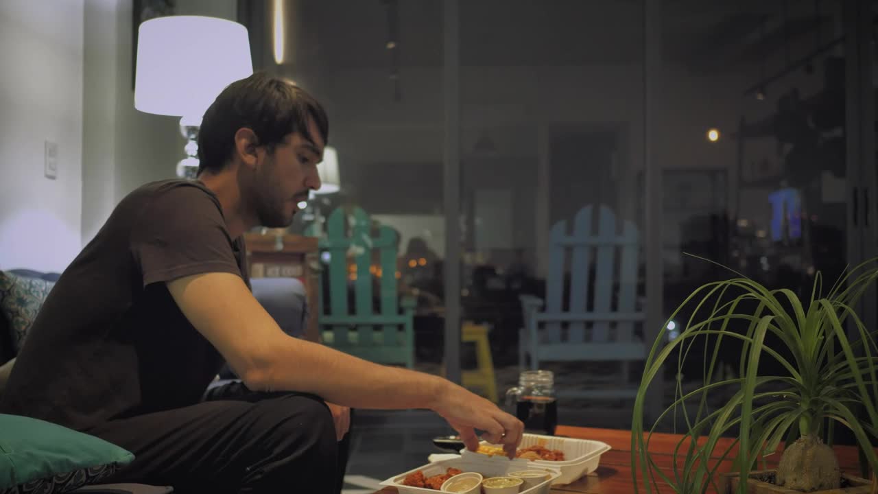 Stock Video Man Eats Watching Television On A Rainy Night Animated Wallpaper - Free Download