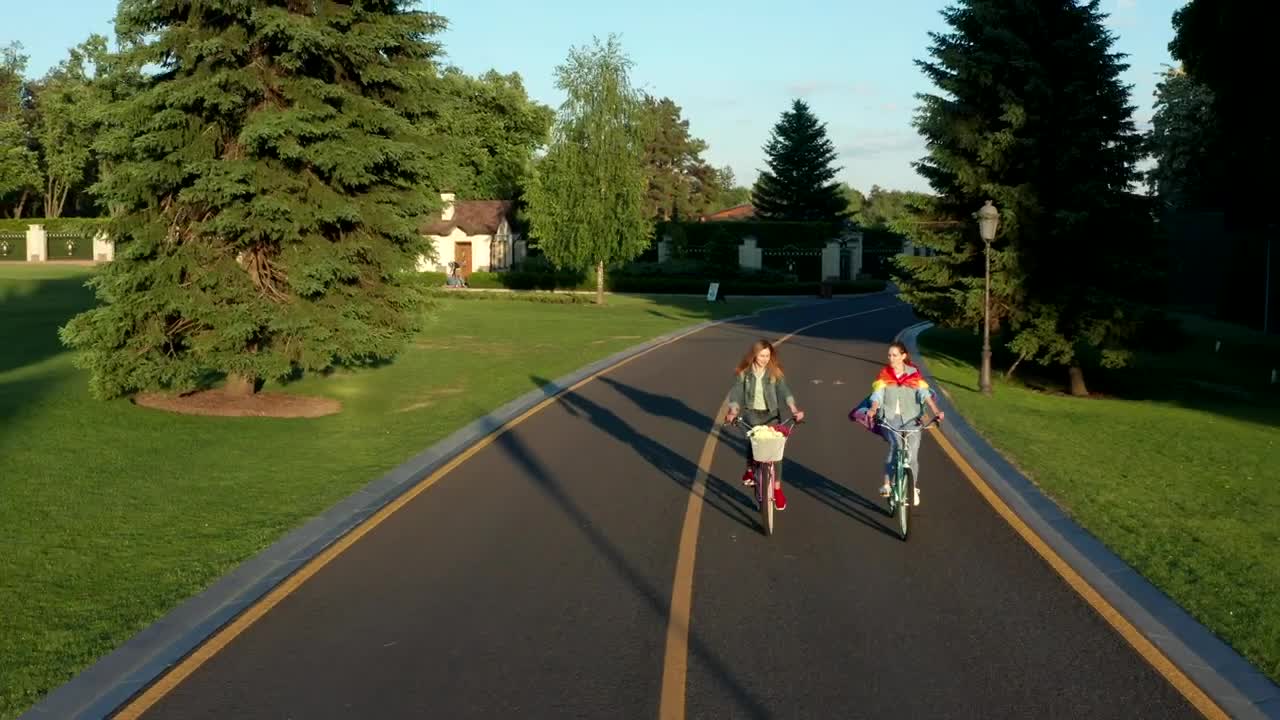 Free Stock Video Two Women Cycling Down A Road In The Suburbs Live Wallpaper - Free Download
