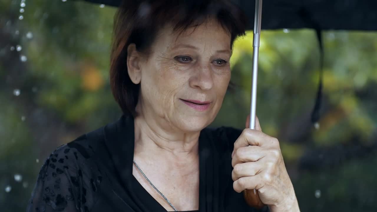 Stock Video Old Sad Woman At A Funeral While Raining Live Wallpaper - Free Download