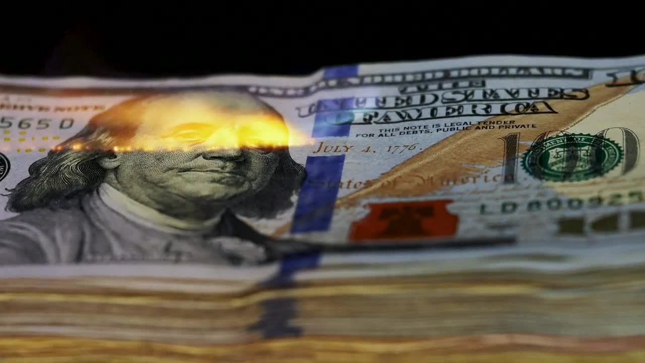Free Video Stock tower of  dollars being burned with a flame Live Wallpaper - Free Download