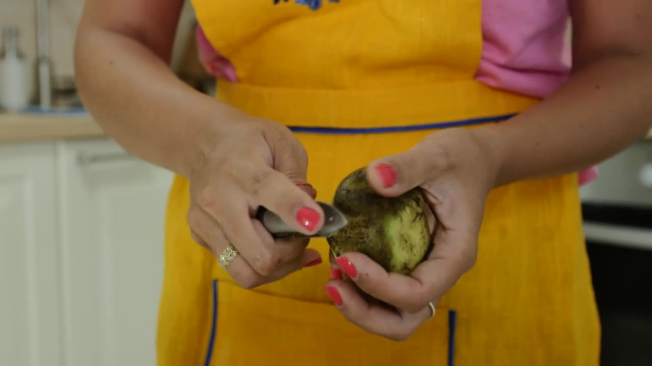 Stock Video Peeling Potatoes In The Kitchen For Dinner Live Wallpaper - Free Download