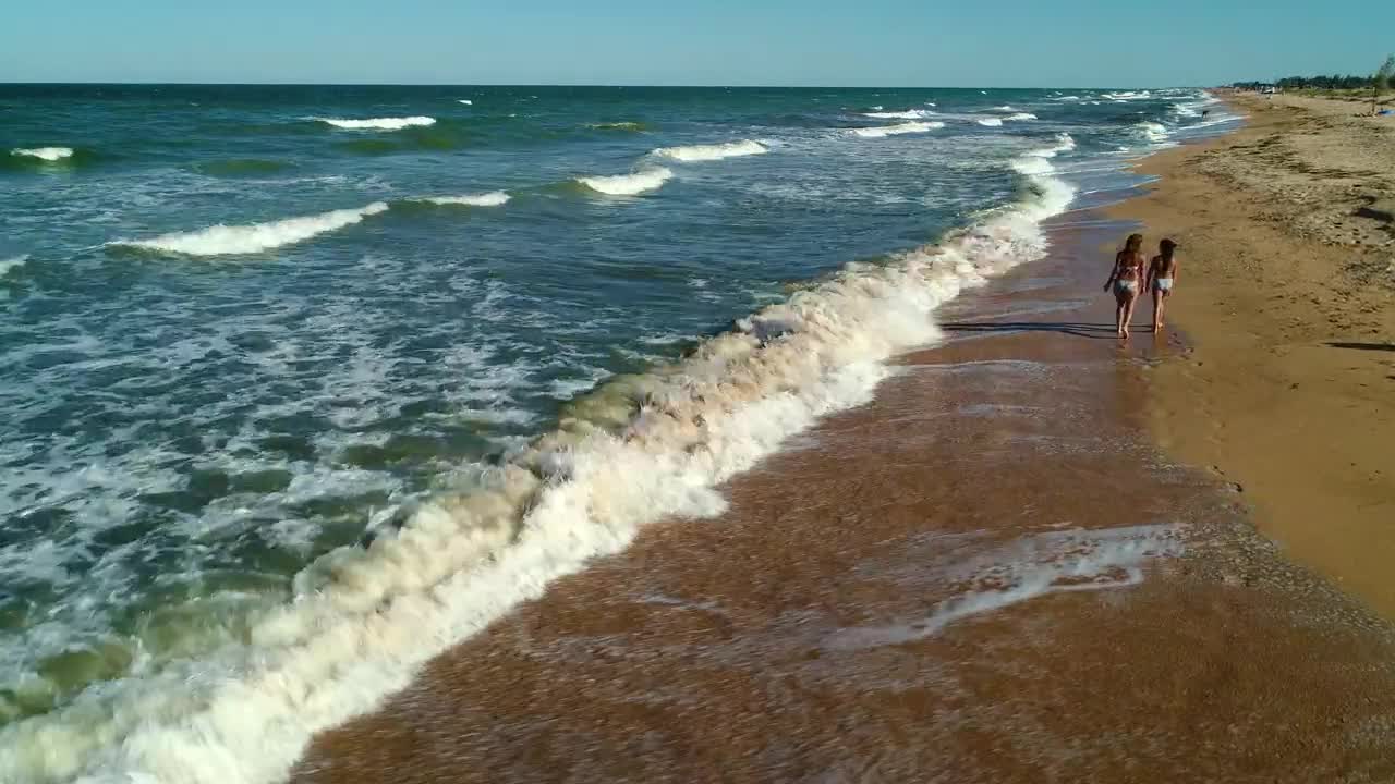 Stock Video Girls Walking On The Sand Next To The Sea Waves Live Wallpaper For PC - Free Download