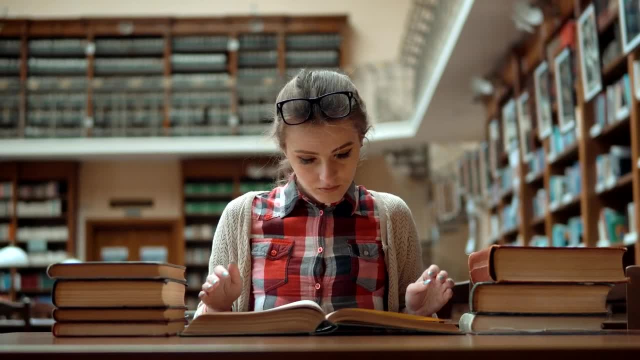 Free Video Stock Student Stressed Over Exam Sits With Books In Library Live Wallpaper - Free Download