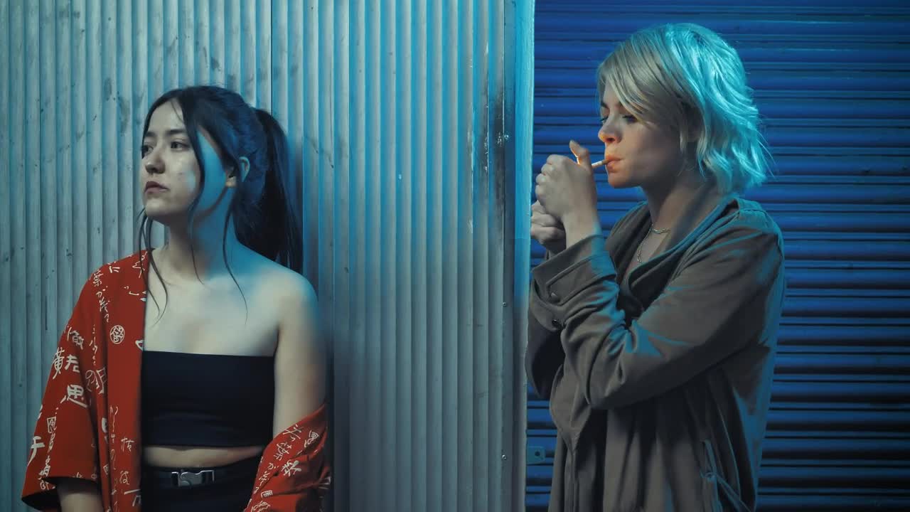 Stock Footage Urban Woman Shares Her Cigarette With Her Friend Live Wallpaper - Free Download