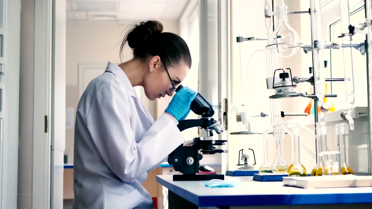 Stock Video Female Scientist Observing Through A Microscope Live Wallpaper For PC - Free Download
