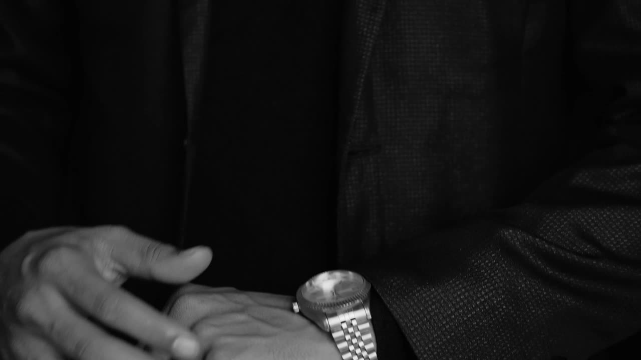 Stock Video Elegant Man In Suit Checks The Time On His Luxurious Live Wallpaper For PC - Free Download