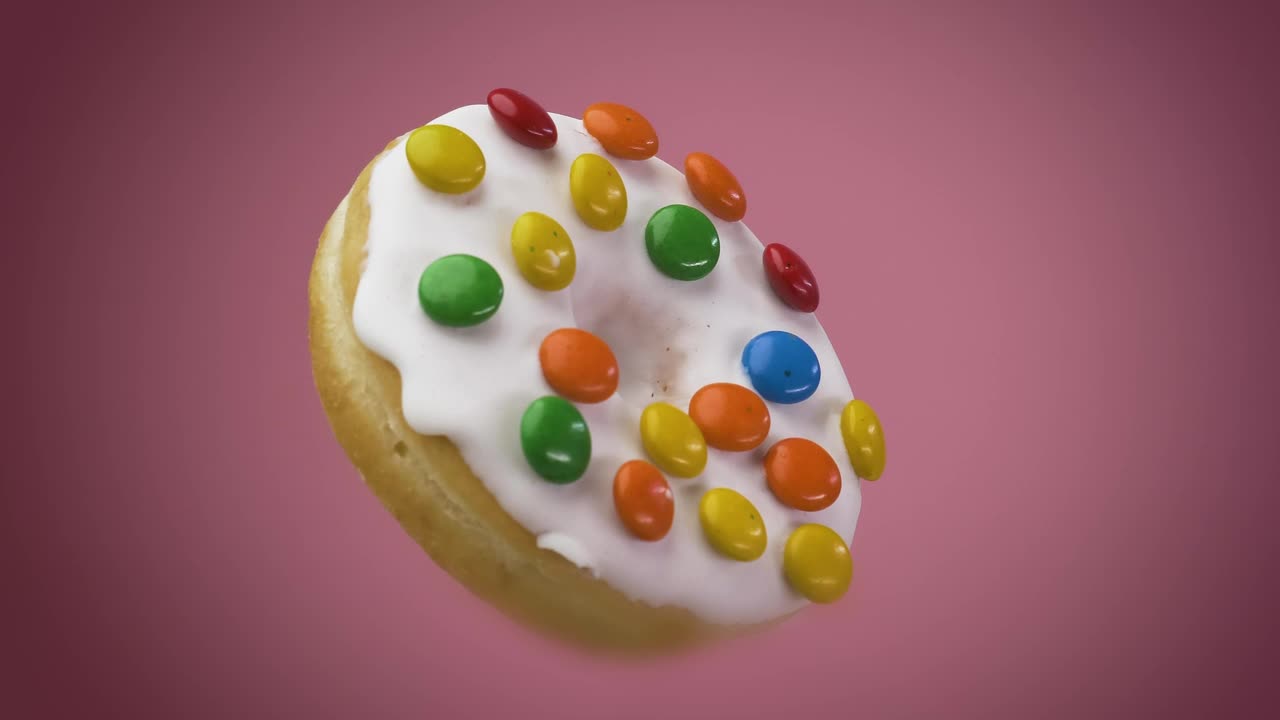 Stock Video Donut With Icing Chocolates Rotating On A Pink Background Live Wallpaper For PC - Free Download