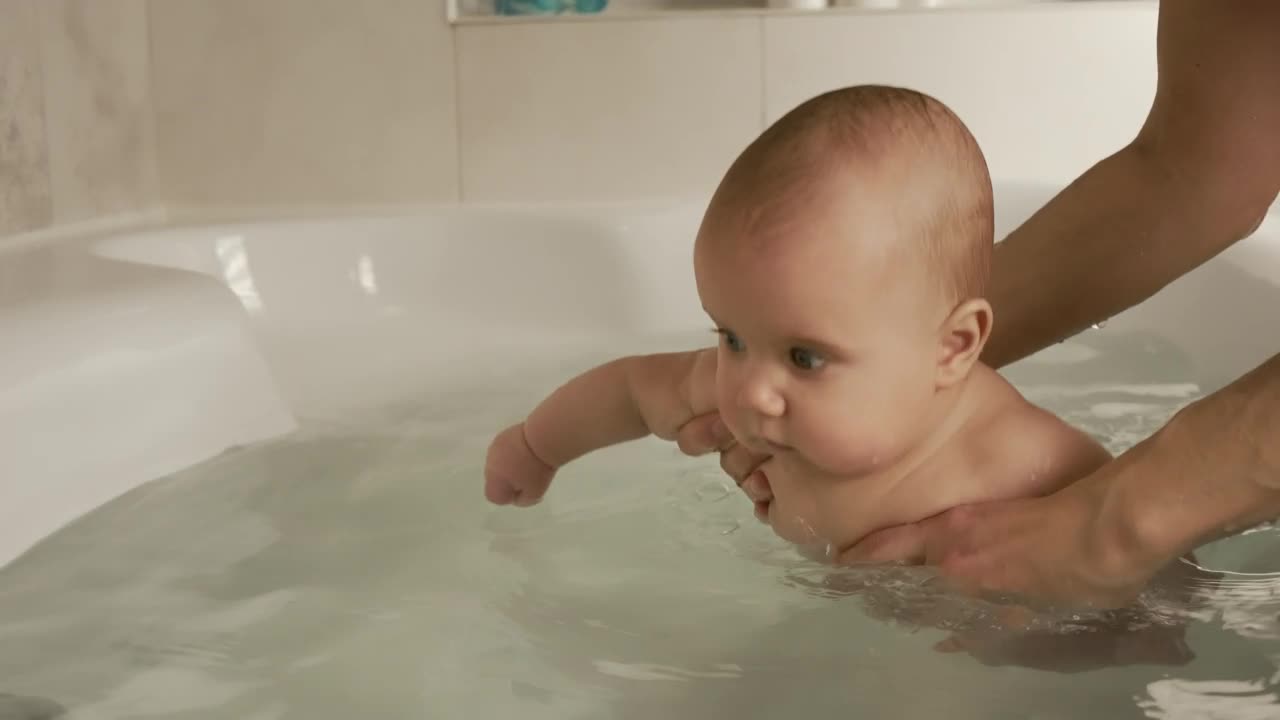 Video Stock Person Puts A Baby In The Bathtub Live Wallpaper Free - Free Download