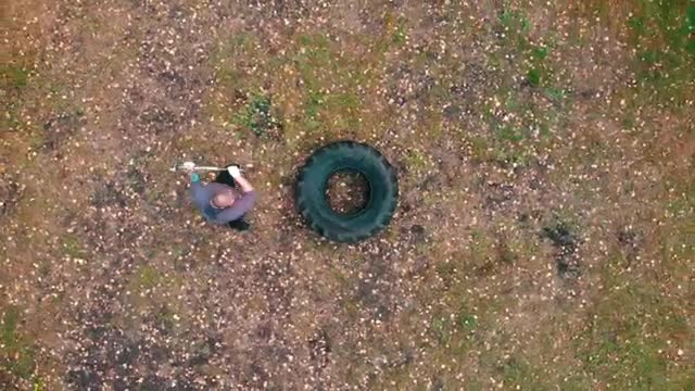 Stock Video Man Hitting A Large Truck Tire With A Mallet Smal Animated Wallpaper - Free Download