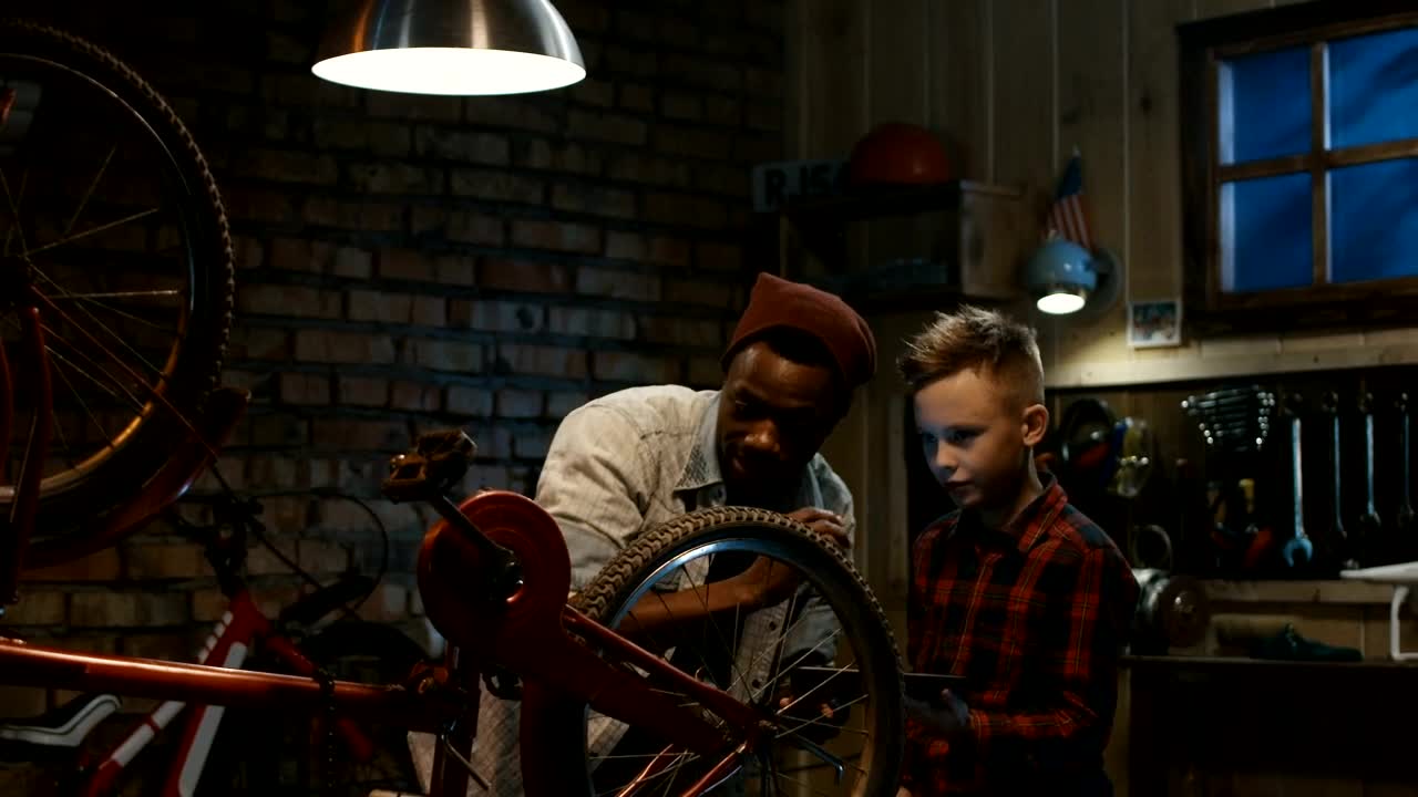 Stock Video Man Teaching A Boy Bicycle Maintenanc Animated Wallpaper - Free Download