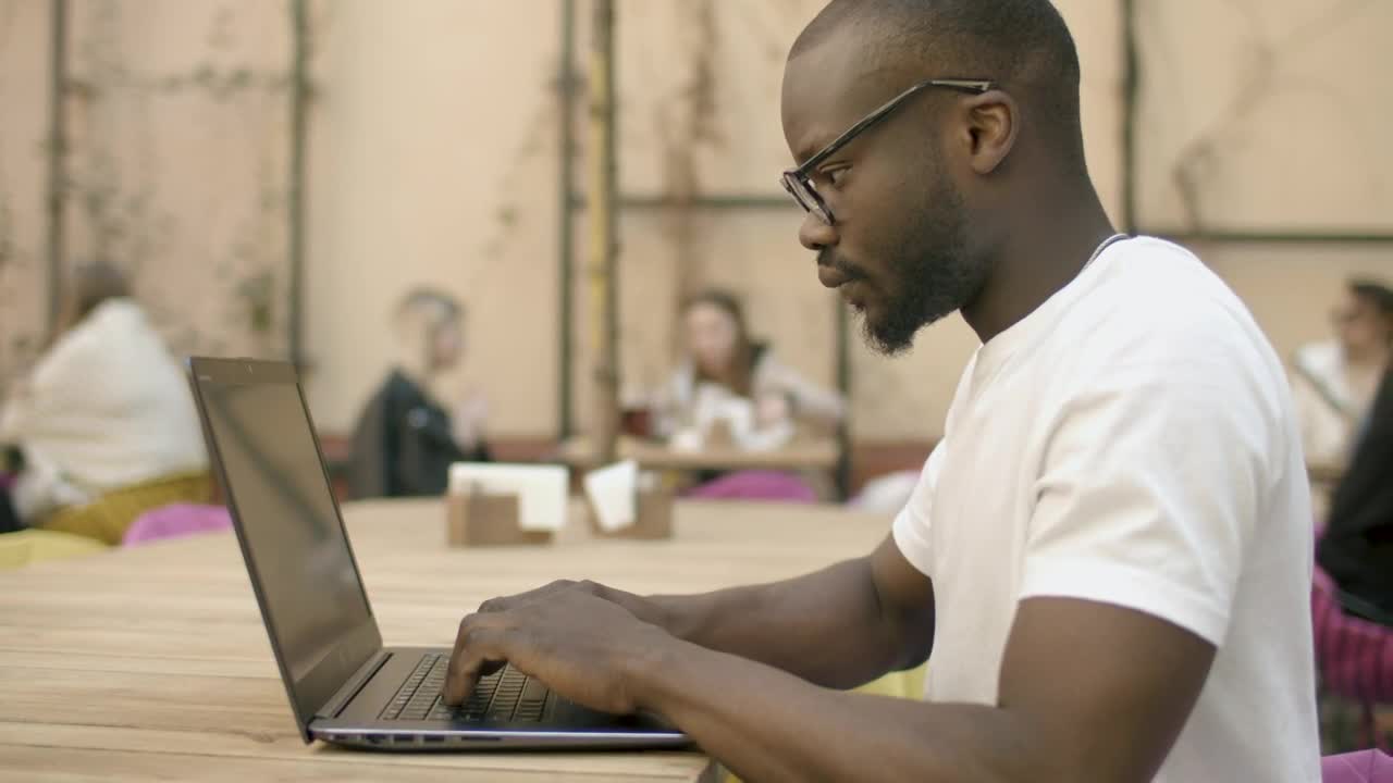 Stock Video Focused Man Types On Laptop In Outdoor Cafe Live Wallpaper For PC - Free Download