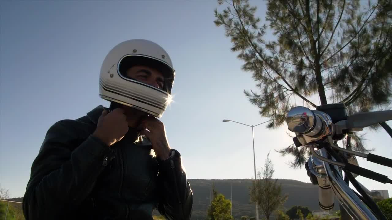 Stock Video Person Fastens Helmet While Atop A Motorcycle Live Wallpaper - Free Download