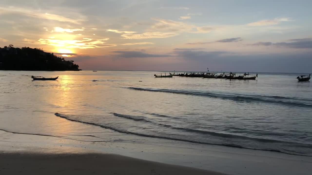 Free Video Stock sunset at a calm beach with boats Live Wallpaper - Free Download