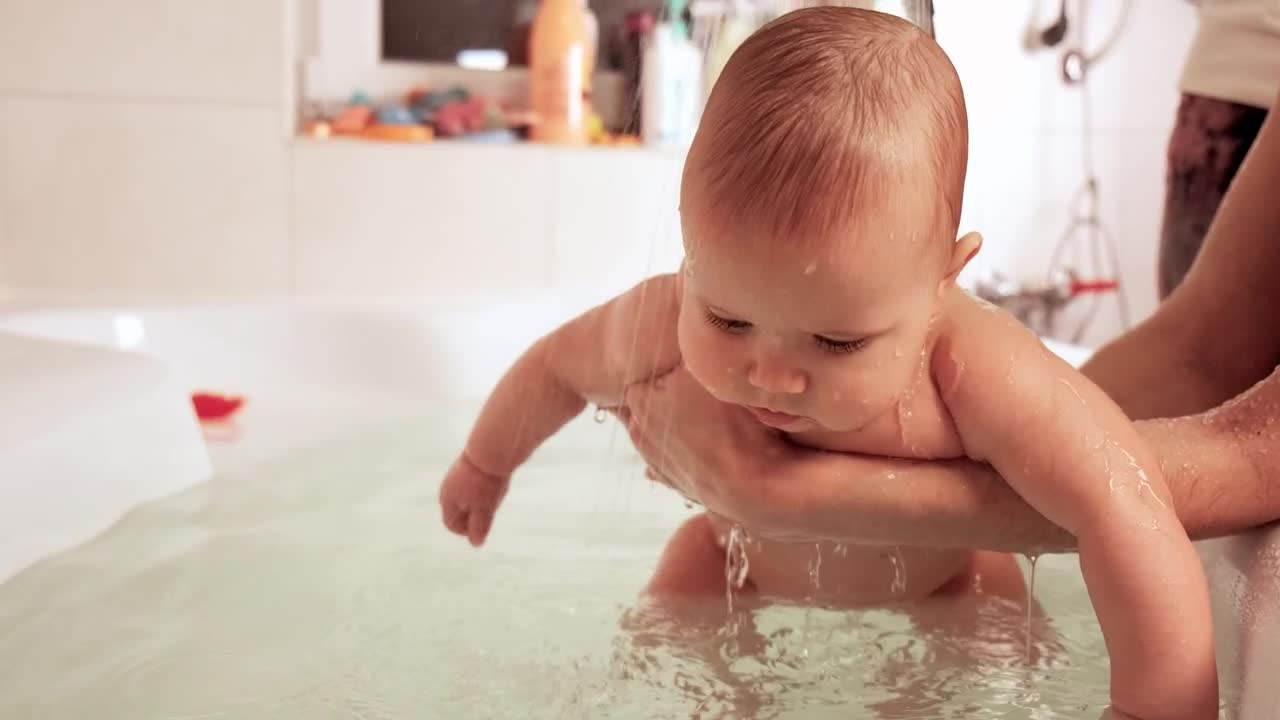 Stock Video Parents Bathing Their Baby In The Tub Live Wallpaper - Free Download