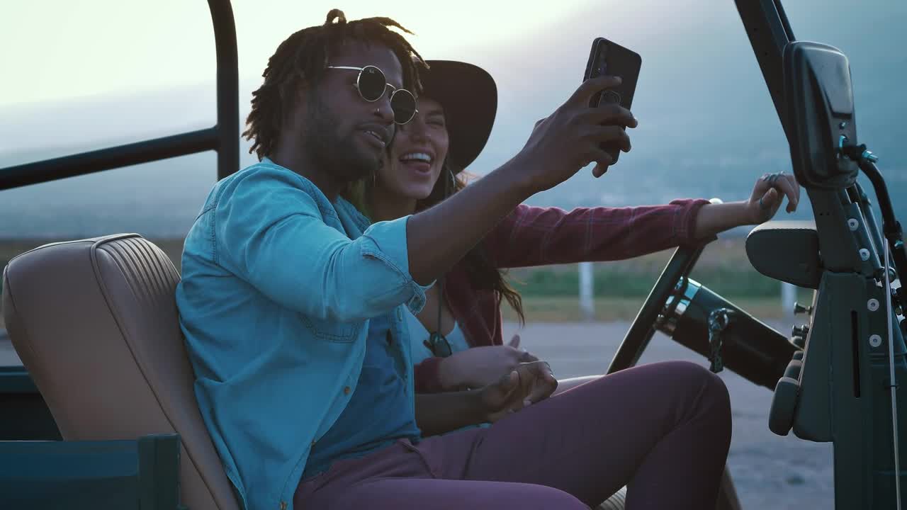 Stock Video Man And Woman Taking Selfies During A Road Trip Animated Wallpaper - Free Download