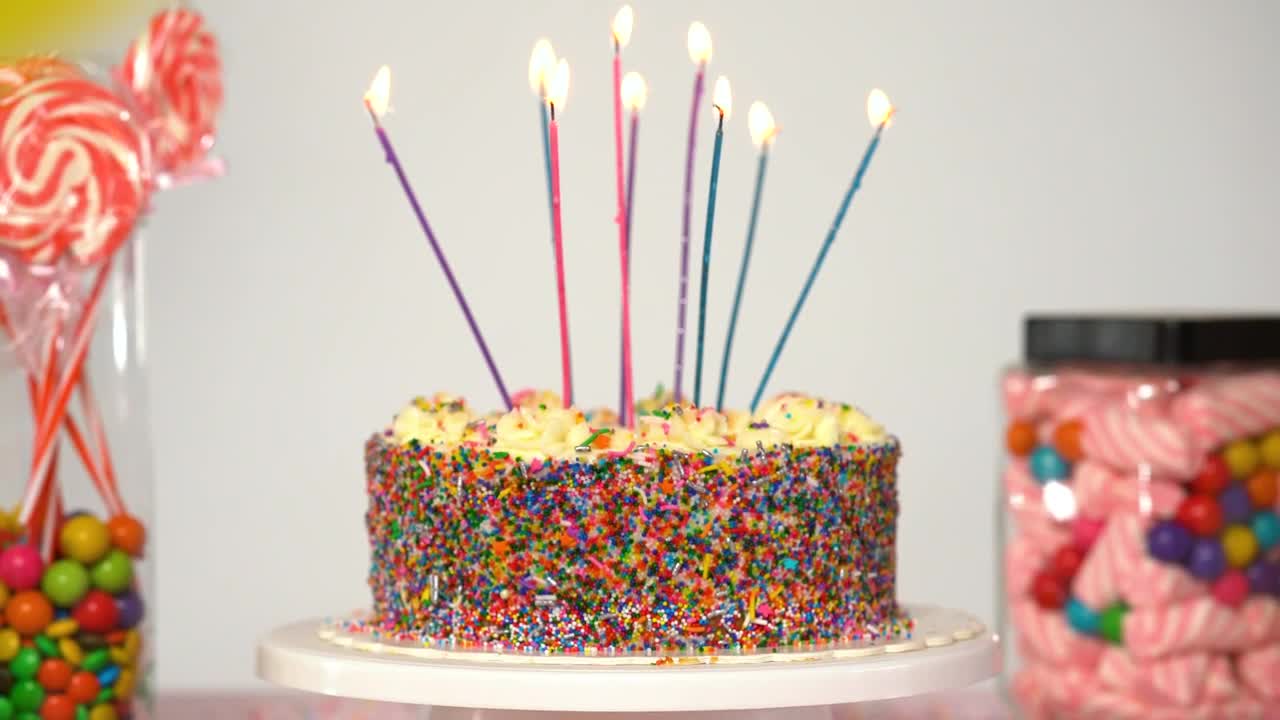 Stock Video Birthday Cake On A Table With Candies On A White Live Wallpaper For PC - Free Download