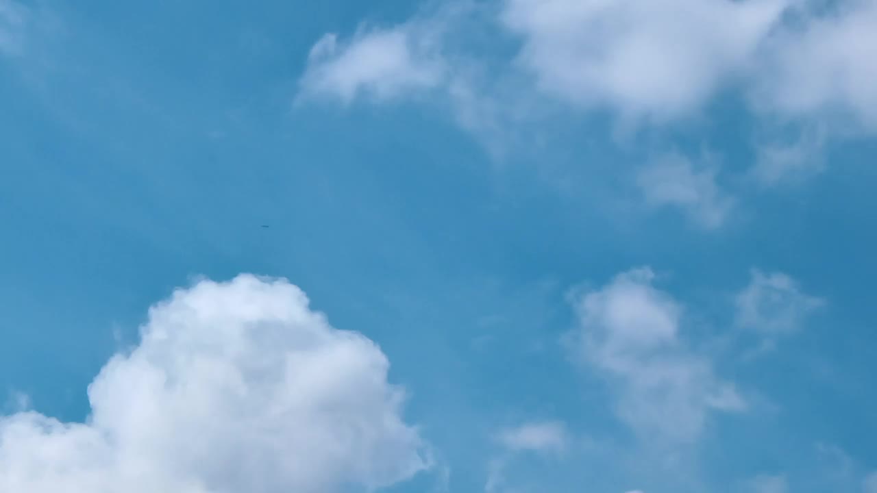 Free Video Stock swirling clouds above a light blue sky Live Wallpaper - Free Download