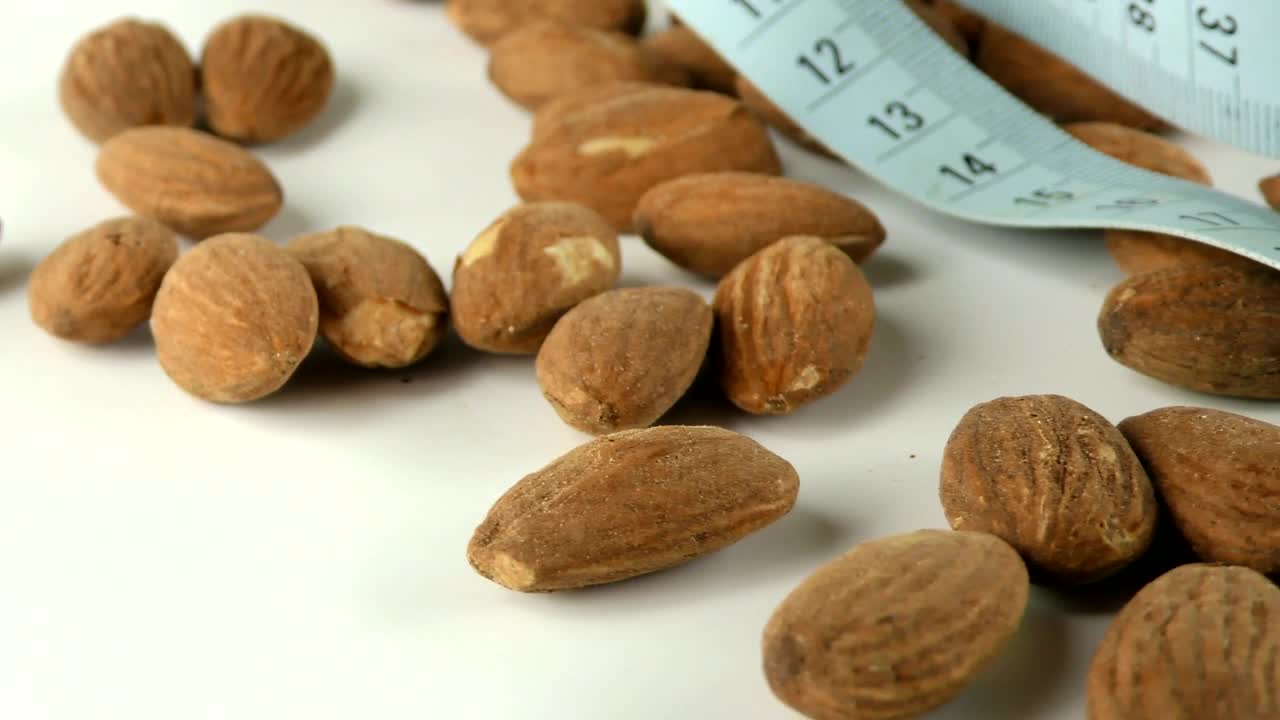 Stock Footage Walnuts And A Blue Measuring Tape Live Wallpaper - Free Download