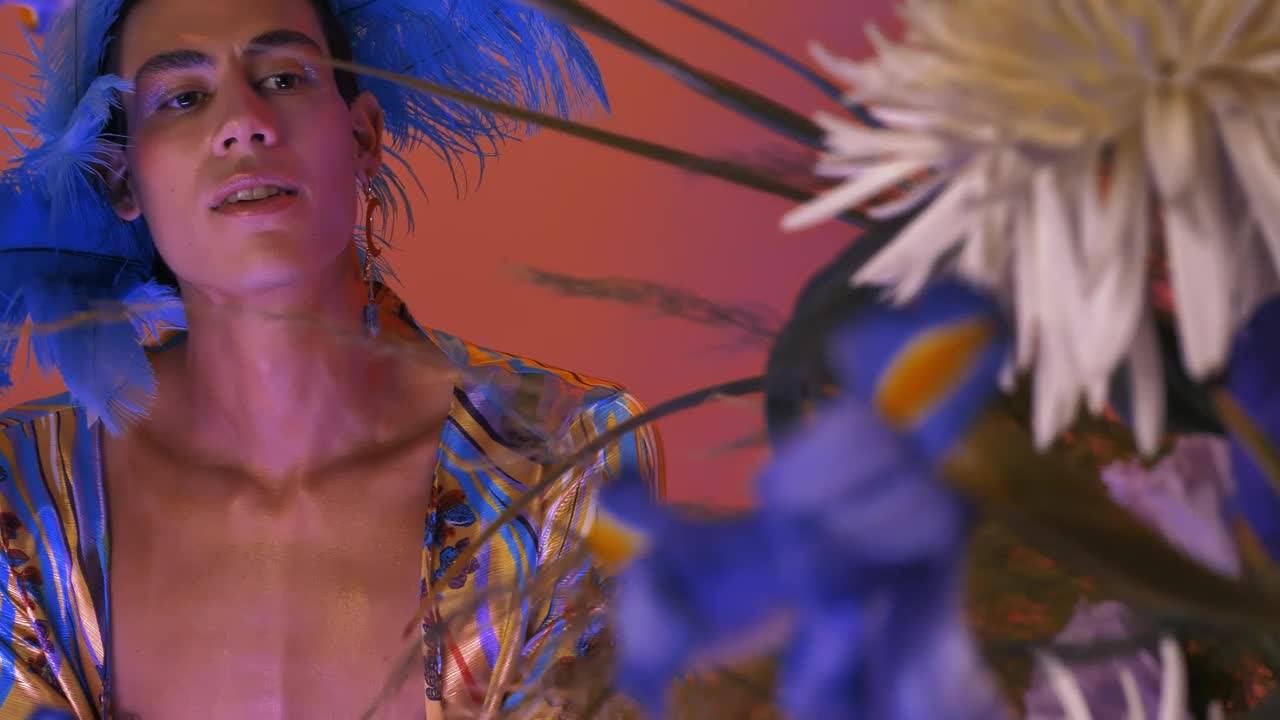 Stock Video Lgbtq Guy With A Striking And Feminine Wardrobe Animated Wallpaper - Free Download