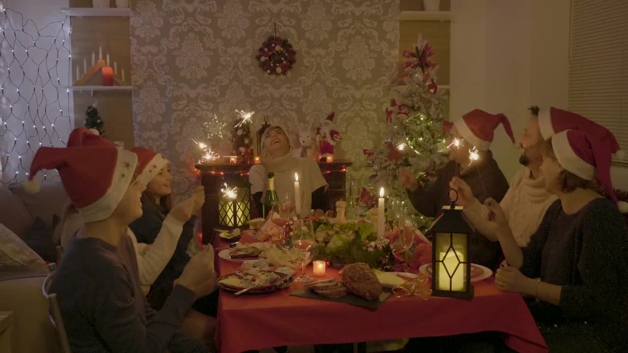 Stock Video Family Sings And Waves Sparklers At Holiday Dinner Live Wallpaper For PC - Free Download