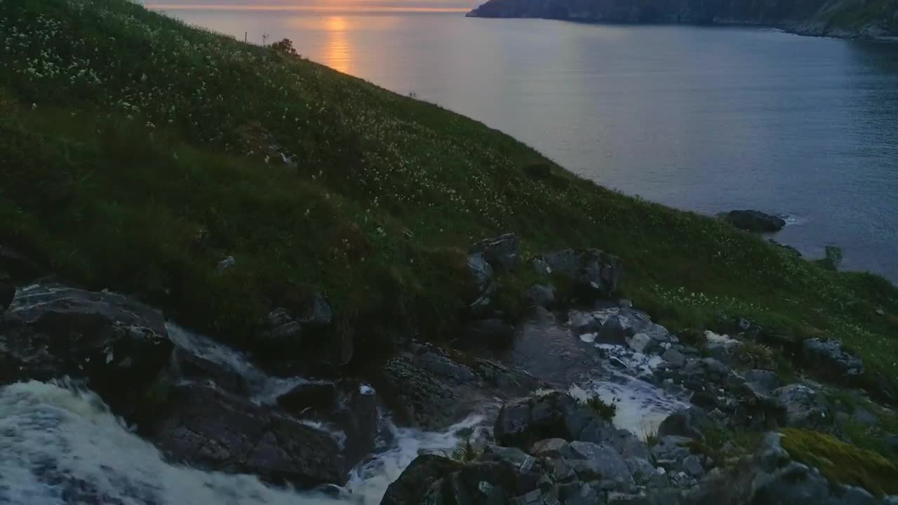 Free Video Stock sunset flyover waterfall and sea coast in norway Live Wallpaper - Free Download