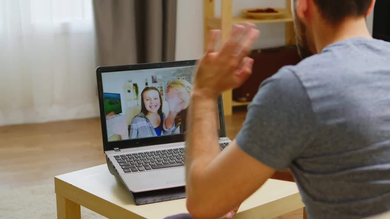 Stock Video Man Waves Hello To Family On Video Cal Animated Wallpaper - Free Download