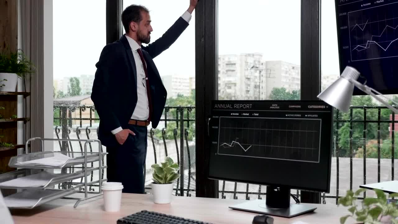 Free Video Stock thinking businessman stands by windows in office Live Wallpaper - Free Download