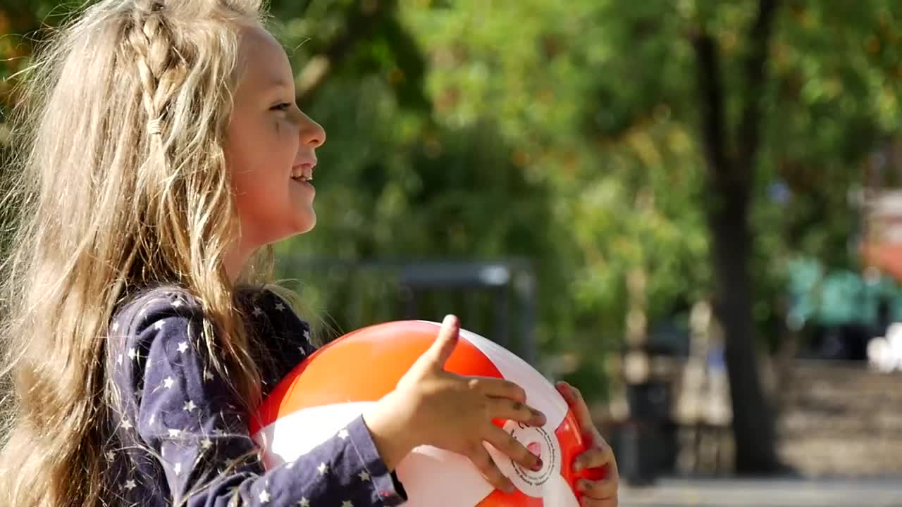 Stock Video Little Girl Smiling Holding Plastic Ball Animated Wallpaper - Free Download