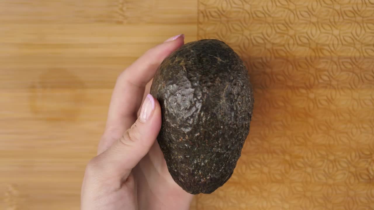Stock Video Female Hands Cutting An Avocado In The Kitchen Live Wallpaper For PC - Free Download