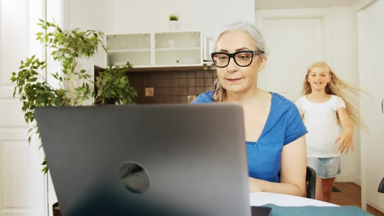Stock Video Girl Greets Grandma While She Works On Laptop Live Wallpaper For PC - Free Download