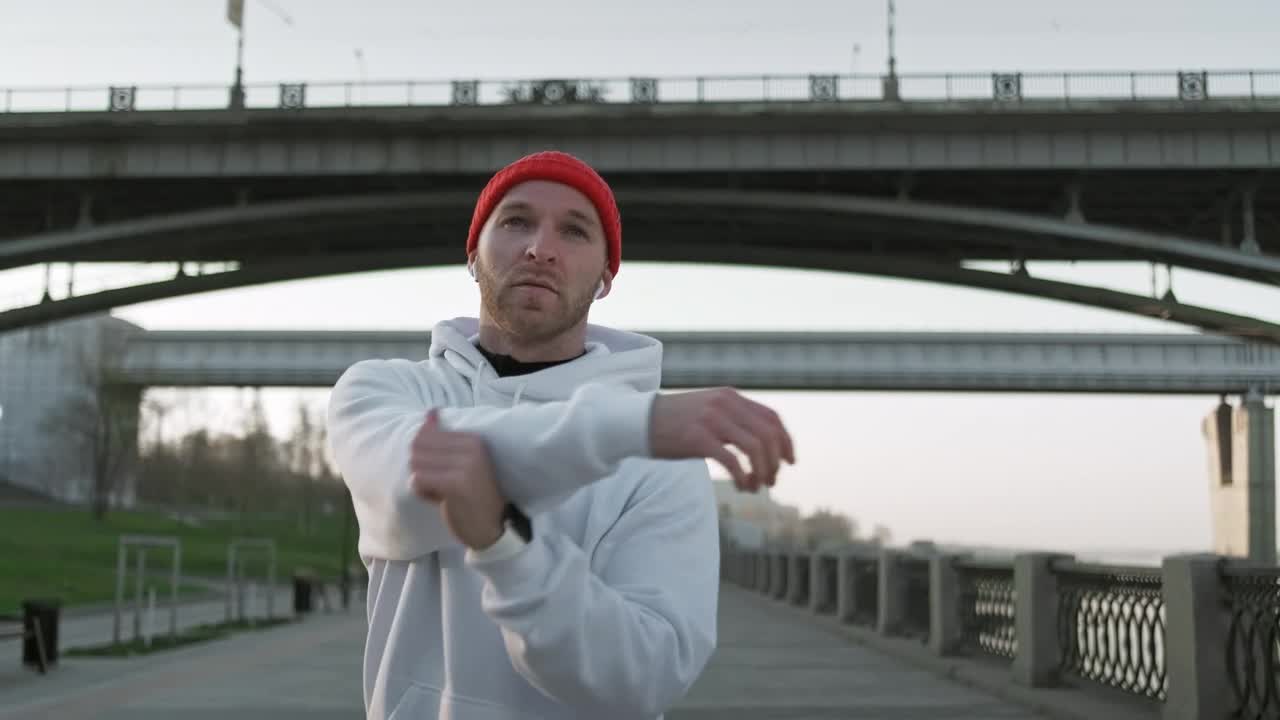 Stock Video Male Athlete Stretching His Arms Before Training Animated Wallpaper - Free Download
