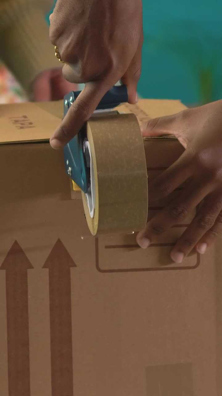 Stock Video Hands Of Two People Sealing A Package With Tape Animated Wallpaper - Free Download