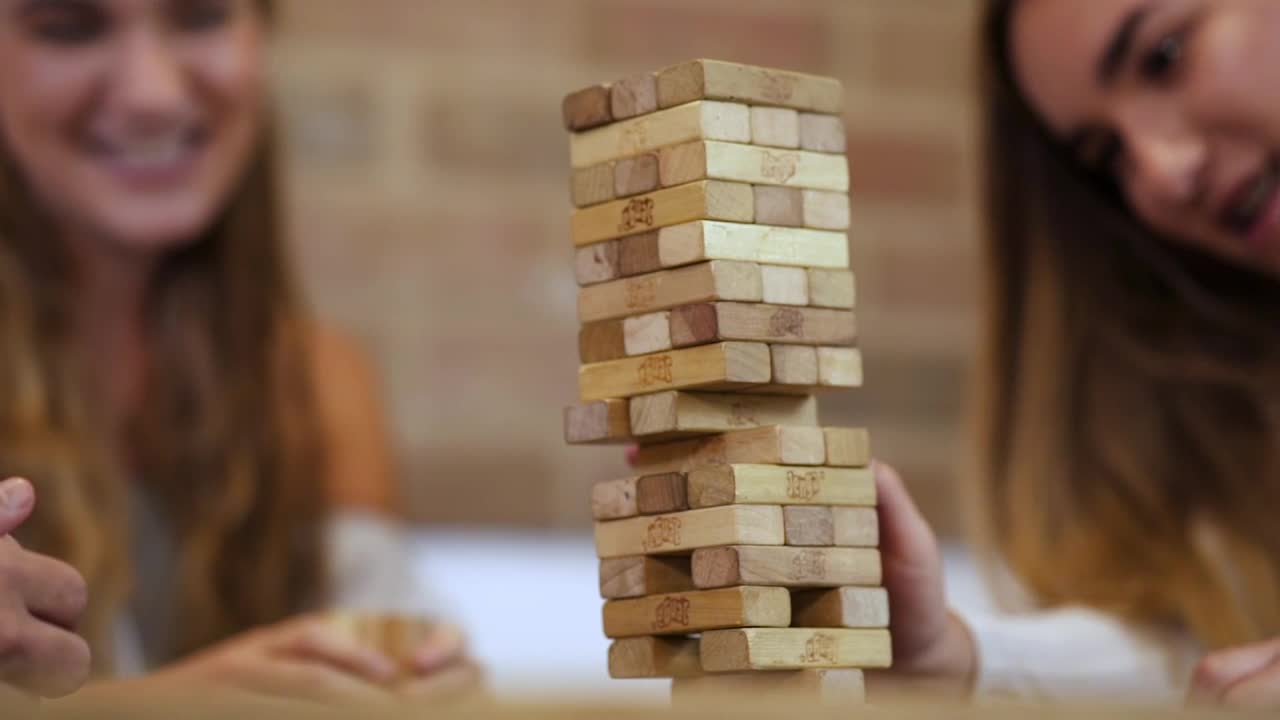 Free Video Stock tearing down a jenga tower in a fun match Live Wallpaper - Free Download