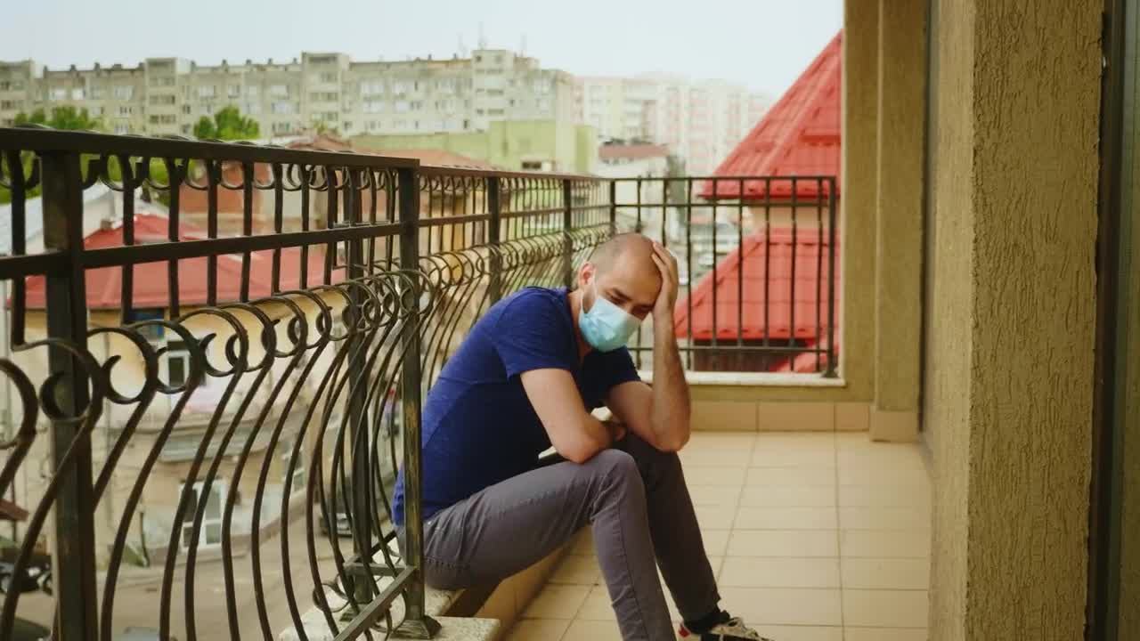 Stock Video Depressed Man Wearing Mask Sits On Balcony In Covid Lockdown Live Wallpaper For PC - Free Download